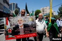 Palestinians attend a protest after the assassination of Hamas leader Ismail Haniyeh in Iran, in Hebron in the Israeli-occupied West Bank, on July 31.