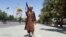 A Taliban fighter poses for a photo as he patrols in the city of Ghazni.