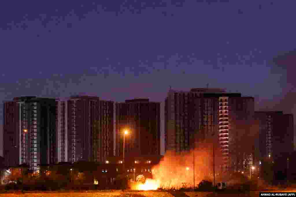 A fire burns outside the grounds of the US embassy in the Iraqi capital of Baghdad on March 17 after a drone and rocket attack on the facility.