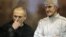 Jailed Russian former oil tycoon Mikhail Khodorkovsky (left) and his business partner Platon Lebedev stand in the defendants' cage before the start of a court session in Moscow in 2010.