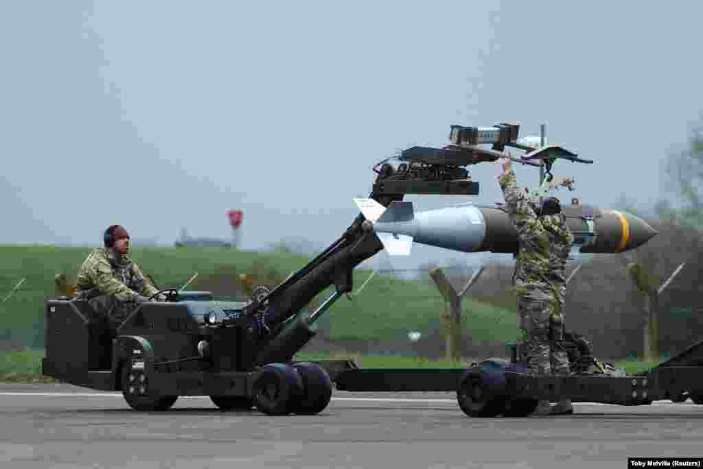 US Air Force personnel handling an aerial bomb at the Fairford base on March 16. 