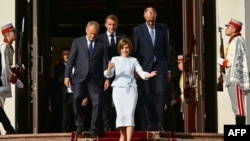 Moldova's President Maia Sandu leads Polish Prime Minister Donald Tusk (L), French President Emmanuel Macron, and German Chancellor Friedrich Merz (R) down the stairs following a press conference in Chisinau, August 27, 2025.