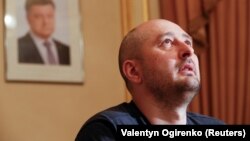 Russian dissident journalist Arkady Babchenko, whose name was not on the alleged "Russian hit list," speaks to the media on May 31 following his faked death, as a portrait of President Petro Poroshenko hangs on the wall behind him.