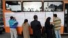 Iran - Iranians choose their candidates from a list on a public bus, designated as a polling station in Tehran, 14Mar2008