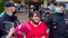 Former municipal deputy Yulia Galyamina in led out of the hotel in Novgorod on May 22. 