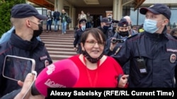 Former municipal deputy Yulia Galyamina in led out of the hotel in Novgorod on May 22. 