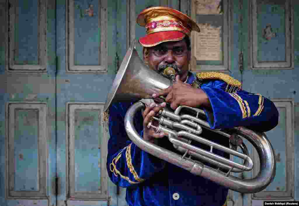 A member of a local band plays his instrument during a marriage ceremony in Mumbai on May 11, 2014.&nbsp;