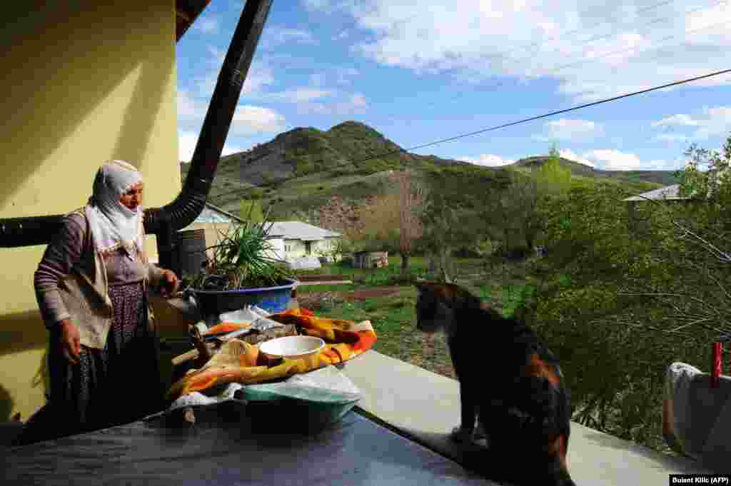 Armenian Muslim Tahire Aslanpencesi works around her house in the village of Mazgirt in Tunceli Province.