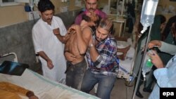 A supporter of Imran Khan, head of the Pakistan Tehrik-e-Insaf opposition party, victim of a stampede, gets medical treatment at a local hospital in Multan, Pakistan 10 October 2014.