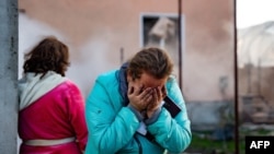 A woman reacts to damage caused to a building following a missile attack at an undisclosed location in the Odesa region in November. (file photo)