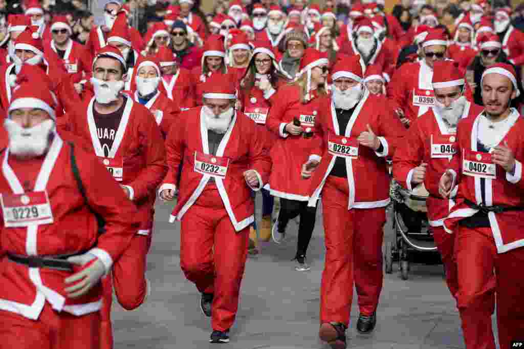 People dressed in Santa Claus costumes take part in a charity race to raise funds for poor families in Kosovo in Pristina. (AFP/Armend Nimani)