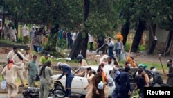  Opposition protesters use sticks to hit a car and a motorcycle as they protest during Revolution March towards the prime minister's house in Islamabad, September 1, 2014.