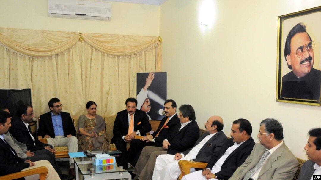 Pakistani Prime Minister Yousaf Raza Gilani (right of center) speaks with leaders of MQM during a meeting at their headquarters in Karachi on January 7.