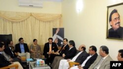 Pakistani Prime Minister Yousaf Raza Gilani (right of center) speaks with leaders of MQM during a meeting at their headquarters in Karachi on January 7.