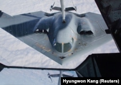 A B-2 Spirit stealth bomber refuels behind a tanker plane above Missouri in October 2022.