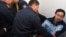 Полицейские уводят оппозиционного активиста Ермека Нарымбаева из зала суда. Алматы, 14 мая 2010 года.