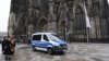 A police car drives in front of the Cologne Cathedral last month.