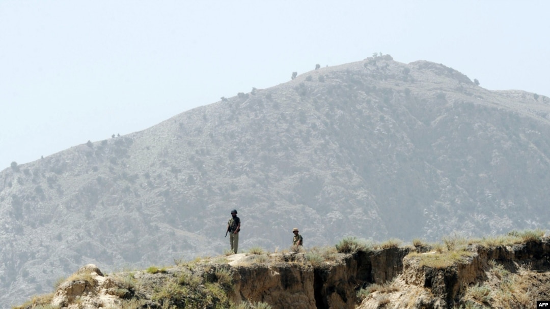 Pakistani soldiers stand guard on a mountain ridge in Pakistan's tribal district of Mohmand Hills.