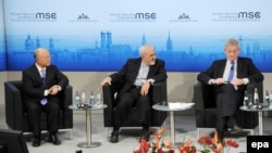 International Atomic Energy Agency chief Yukiya Amano (left to right), Iranian Foreign Minister Mohammad Javad Zarif, and Swedish Foreign Minister Carl Bildt participate in the Munich Security Conference in Munich, Germany, on February 2.