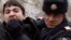Azerbaijan - A policeman detains an opposition activist in Baku March 12, 2011. Azerbaijan police detained more than 30 activists of the opposition Musavat Party when its members took to the street of Baku on Saturday to protest against the ruling elite f
