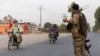 A member of the Afghan special forces directs traffic during an operation in Kandahar Province on July 13.