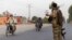 A member of the Afghan special forces directs traffic during an operation in Kandahar Province on July 13.