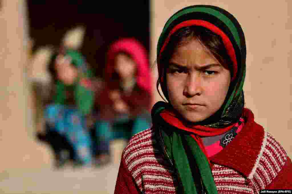 Një vajzë afgane, e cila është zhvendosur nga shtëpia e saj për shkak të dhunës, është fotografuar pranë një strehe të përkohshme në Herat.(epa-EFE/Jalil Rezayee)