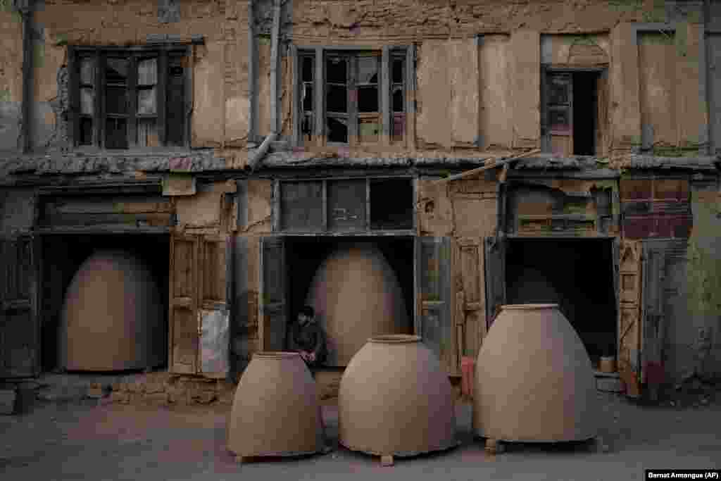 An Afghan potter sits among tandoor ovens in Kabul.&nbsp;