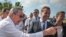 Cuban President Raul Castro (left) and Russian Prime Minister Dmitry Medvedev talk to journalists after a visit to the Soviet Soldier Monument in Havana on February 22.