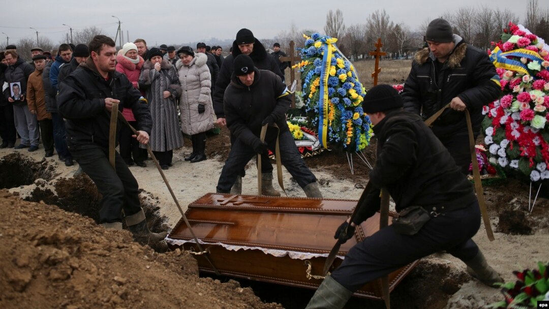 Ukraine -- People attend the funeral ceremony for Aleksandr Demyanenko who was killed during the 24 January shelling of the eastern Ukrainian city, in Mariupol, January 26, 2015