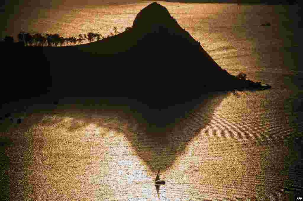 A boat sails in Guanabara Bay during sunset in Rio de Janeiro, Brazil, on April 9. (AFP/Christophe Simon)