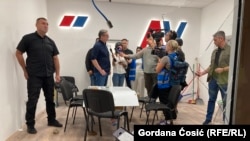 Serbian President Aleksandar Vucic in the damaged premises of the ruling Serbian Progressive Party on August 18