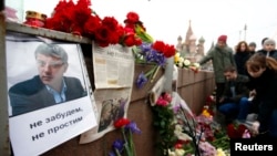 People gather earlier this year at the site where Boris Nemtsov was murdered in central Moscow in February.