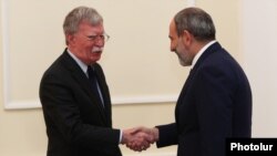 Acting Armenian Prime Minister Nikol Pashinian (right) meets with U.S. national-security adviser John Bolton in Yerevan on October 25.