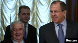 Syrian Foreign Minister Walid al-Moallem (left) with Russian Foreign Minister Sergei Lavrov (right) before a meeting in Moscow on January 17