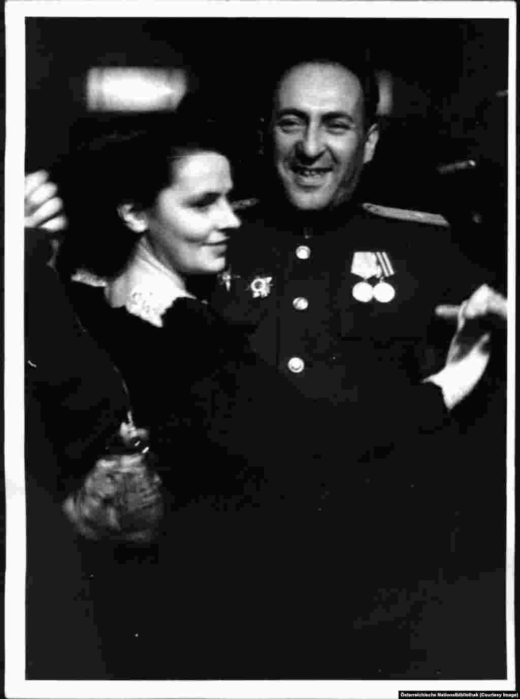 A Soviet information officer waltzing with a young woman.