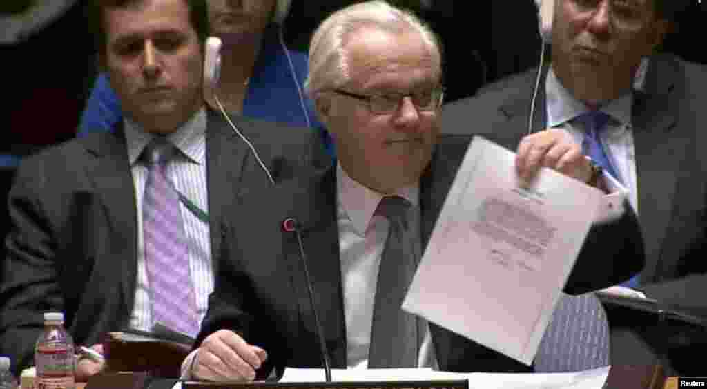 Vitaly Churkin, Russian ambassador to the UN, shows a letter to the UN Security Council on March 3 purportedly from ousted Ukrainian leader Viktor Yanukovych to Vladimir Putin asking the Russian leader for military intervention in Ukraine. (Reuters)