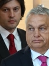 Georgian Prime Minister Irakli Kobakhidze and visiting Hungarian Prime Minister Viktor Orban arrive for a joint briefing at the state chancellery in Tbilisi on October 29, 2024. (Photo by Vano SHLAMOV / AFP)