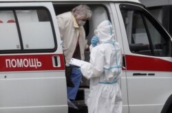 Коронавирус жұққан науқас жедел жәрдем көлігінен түсіп жатыр. Көрнекі сурет.