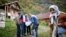 Bosnian Muslims speak with a census taker in the village Krusev Do, near Srebrenica on October 1