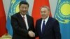 Kazakh President Nursultan Nazarbaev (right) and Chinese President Xi Jinping shake hands during a joint news conference following their meeting in Astana on June 8.
