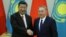 Kazakh President Nursultan Nazarbaev (right) and Chinese President Xi Jinping shake hands during a joint news conference following their meeting in Astana on June 8.