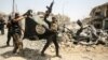 Members of the Iraqi Counterterrorism Service cheer as they carry an upside-down flag of the Islamic State extremist group, with the destroyed Grand Al-Nuri Mosque seen in the background, in the Old City of Mosul on July 2.