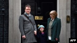 Richard Ratcliffe, husband of British-Iranian aid worker Nazanin Zaghari-Ratcliffe jailed in Tehran since 2016, his daughter Gabriella and his mother Barbara, pose outside of at 10 Downing Street in central London on January 23, 2020, to meet with Britain's Prime Minister. AFP