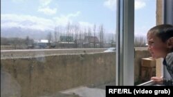 One of Habibulla Muhammad-uulu’s son looks out the window of the family’s home in Naryn, Kyrgyzstan where they moved after leaving Afghanistan’s remote Big Pamir valley.