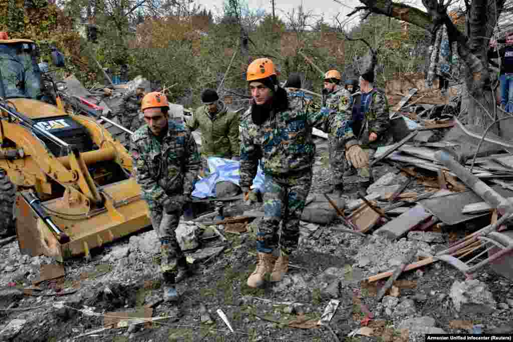 Rescuers carry the victim of a rocket attack on the city of Stepanakert on November 6.&nbsp;