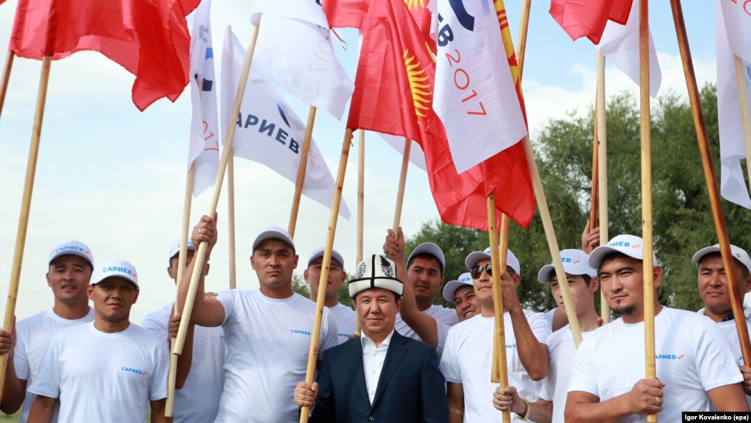 Presidential candidate Temir Sariev (center) meets with local residents while campaigning in the village of Kun-tuu, near the capital, Bishkek, on September 11.