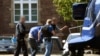 Suspected Islamist militant Magomed-Ali C. (second left, under the blanket) is escorted by German police officers to a helicopter after an arrest hearing at the Federal Court of Justice in Karlsruhe in August last year. 