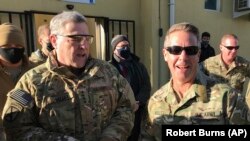 Chairman of the U.S. Joint Chiefs of Staff General Mark Milley (left) talks with General Scott Miller, commander of U.S. and coalition forces in Afghanistan, in Kabul in December 2020.