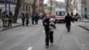 A woman walks with her dog at the site of a Russian missile strike in Kharkiv, Ukraine, on November 25.